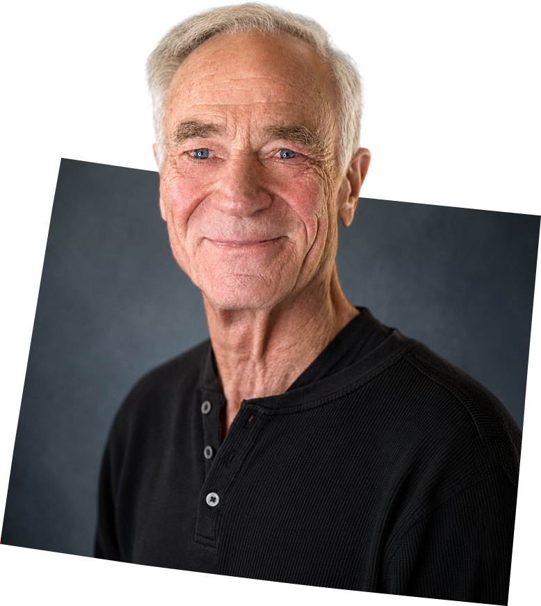Dave Kinskey posing in front of a gray scale background in the shape of Wyoming